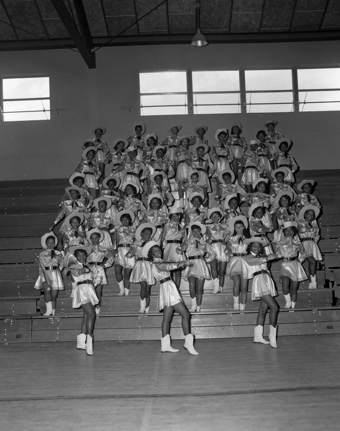 #139 Anderson High School cheerleaders posing on school bleachers, 1955