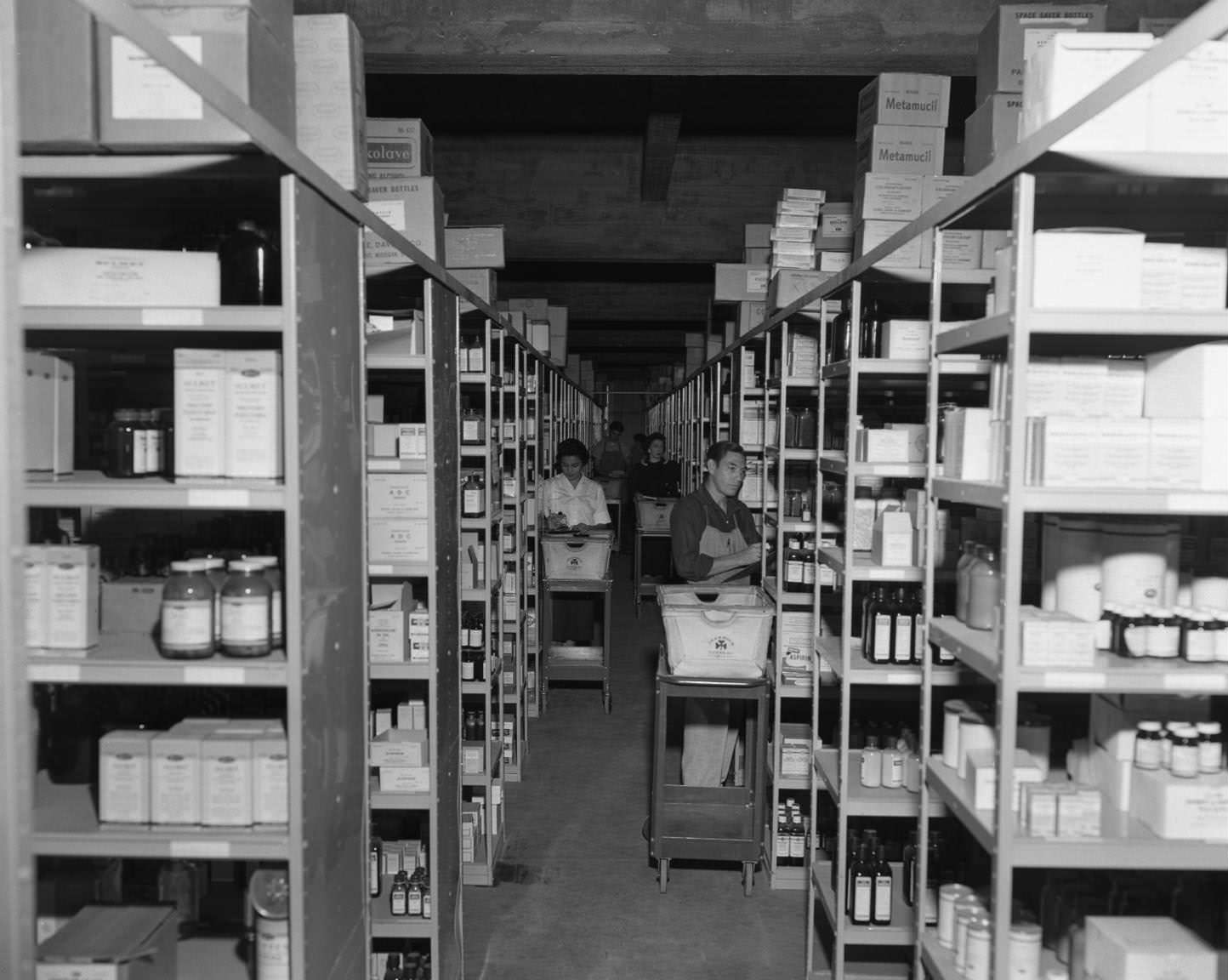 #168 Employees loading shelves of medicine at Behrens Drug Co., 5th and Colorado, 1957