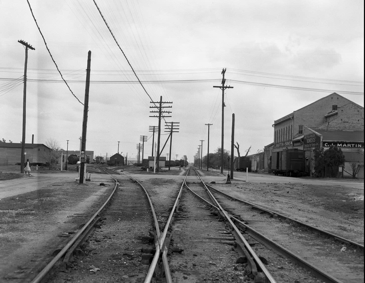 #184 Looking East from the 1700 block of E. 5th at the railroad tracks at Chicon. C. J. Martin & Sons on the right, 1951