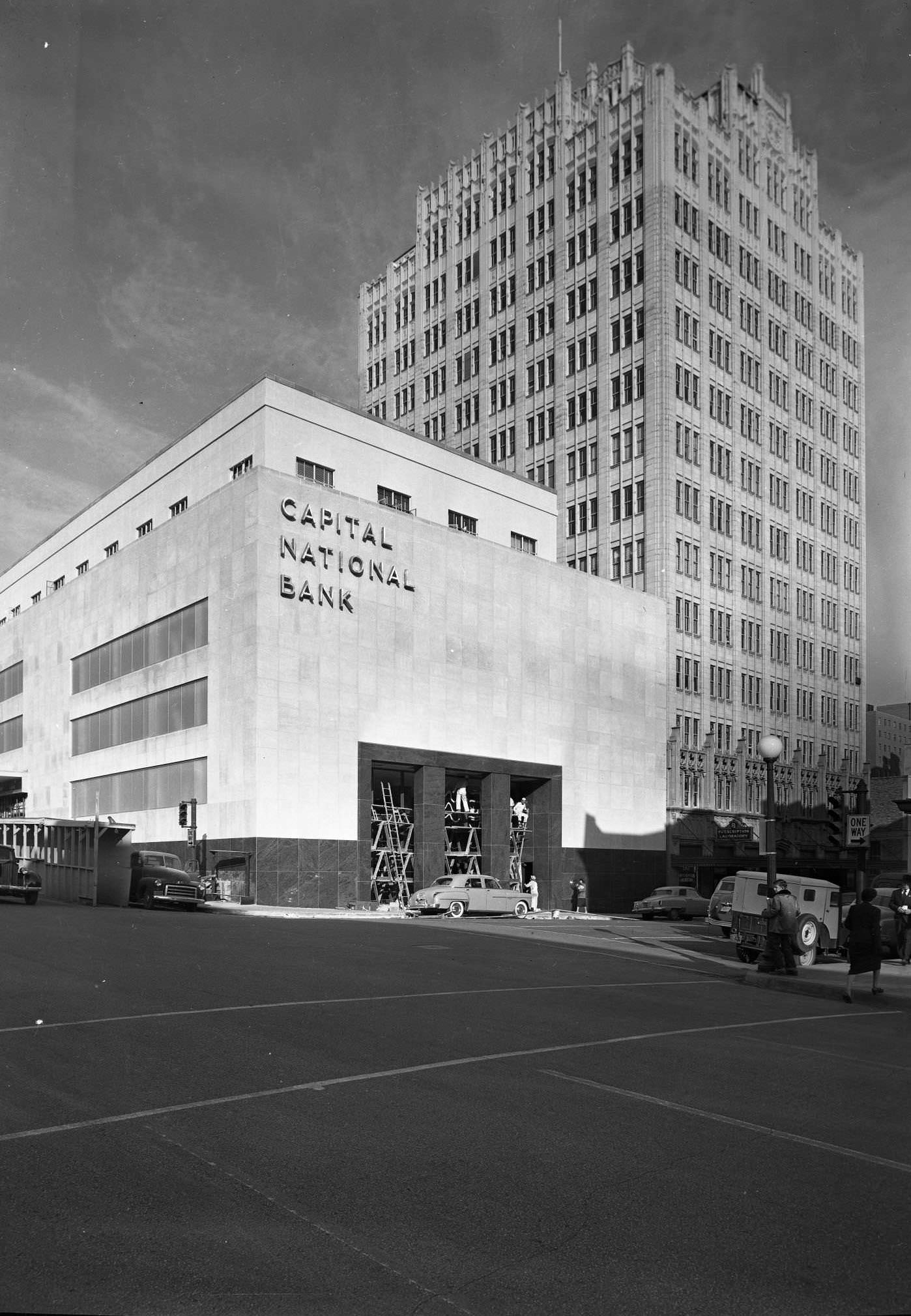 #186 Looking northeast at the building at 114-120 W. 7th St from the intersection of 7th and Colorado St. Still under construction. Norwood Tower in view, 1951