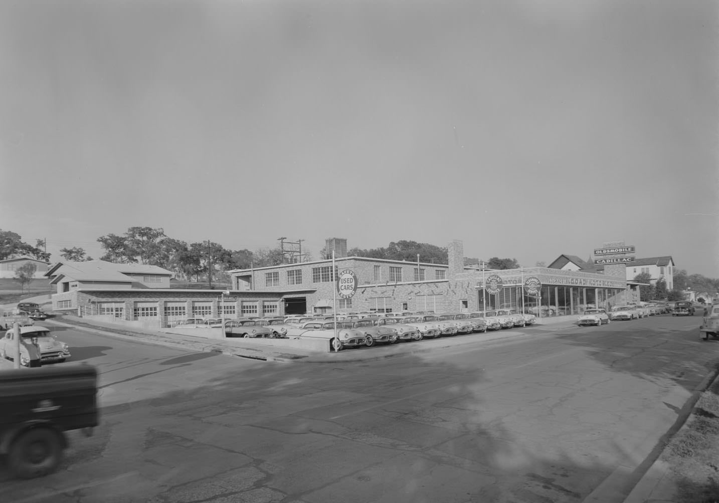 #191 View of Goad Motor Company showroom and lot with cars, 1956