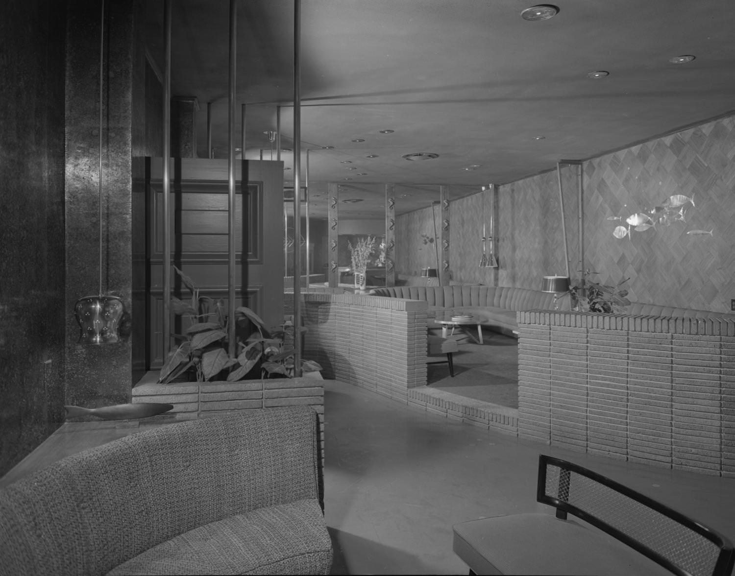 #50 The Austin Club lounge with a seating area enclosed in a low brick wall, 1955