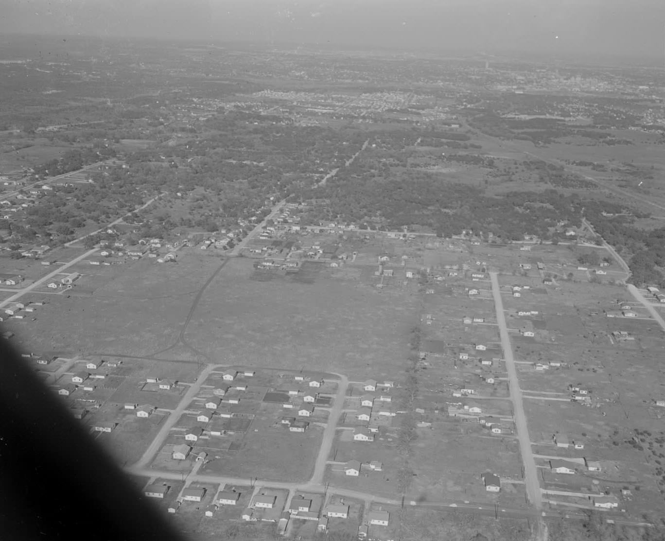 #3 Aerial view of Austin with the Tower and Capitol barely visible in the background, 1953