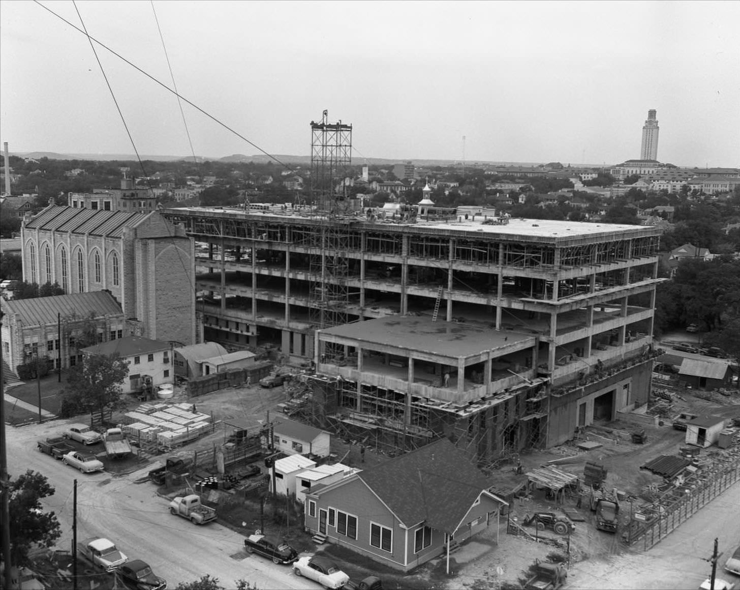 #75 Aerial shot of steel frame structure of TEC building. Brazos St is on the lower right and 14th on the lower left, 1958