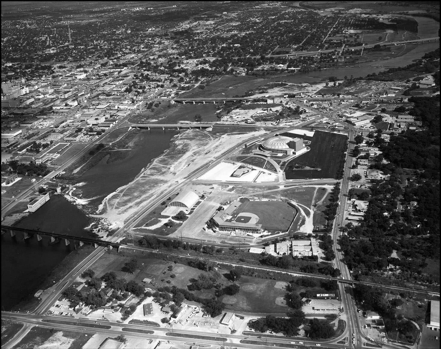 #35 Aerial shot over Colorado River, looking east past Congress Ave. Bridge and Auditorium Shores, 1959