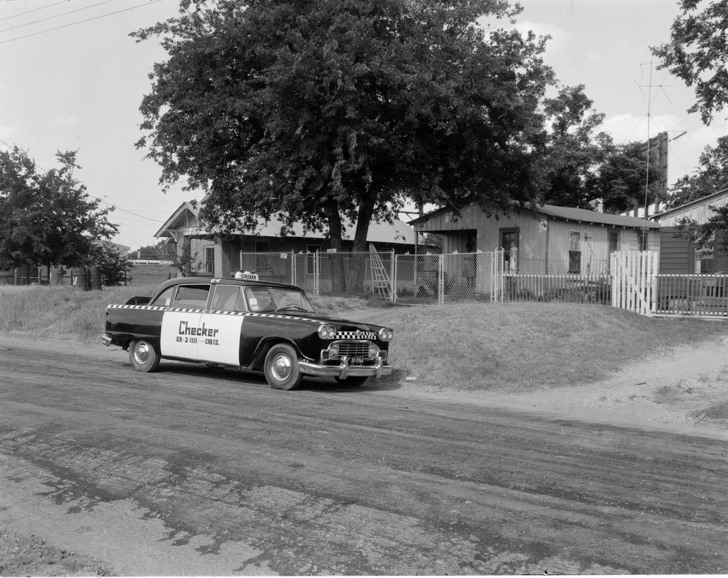 #160 Checker cab parked on a residential street, Austin, 1962