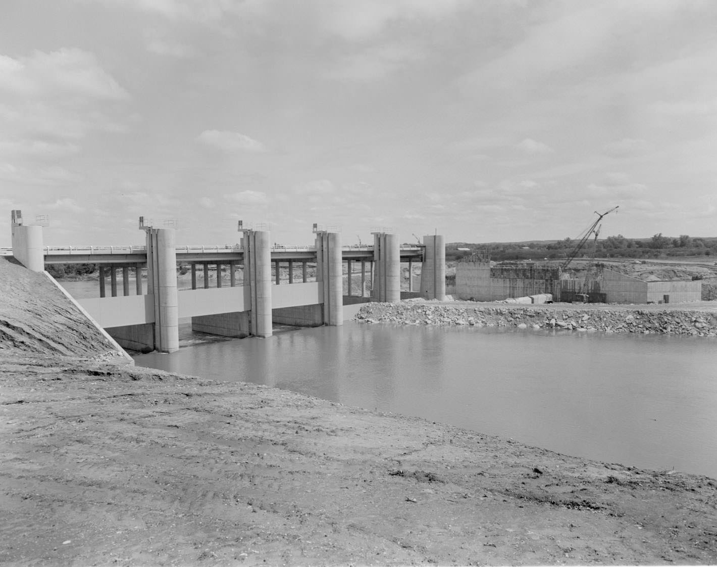 #169 Longhorn Dam, looking southwest, Austin, 1966. Pleasant Valley Rd. crosses the dam which was built to provide water for Holly Street power plant.