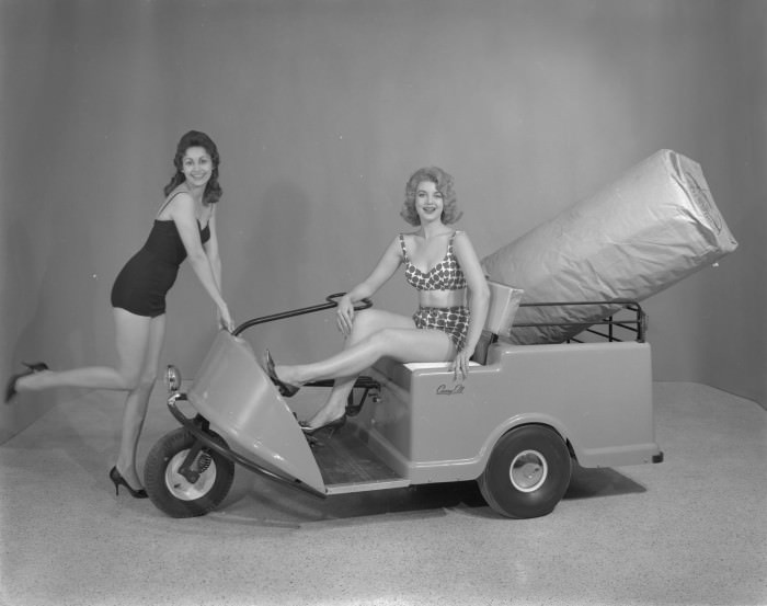 #180 Two women posing to advertise a motorized cart for Powered Products of Texas, 1960
