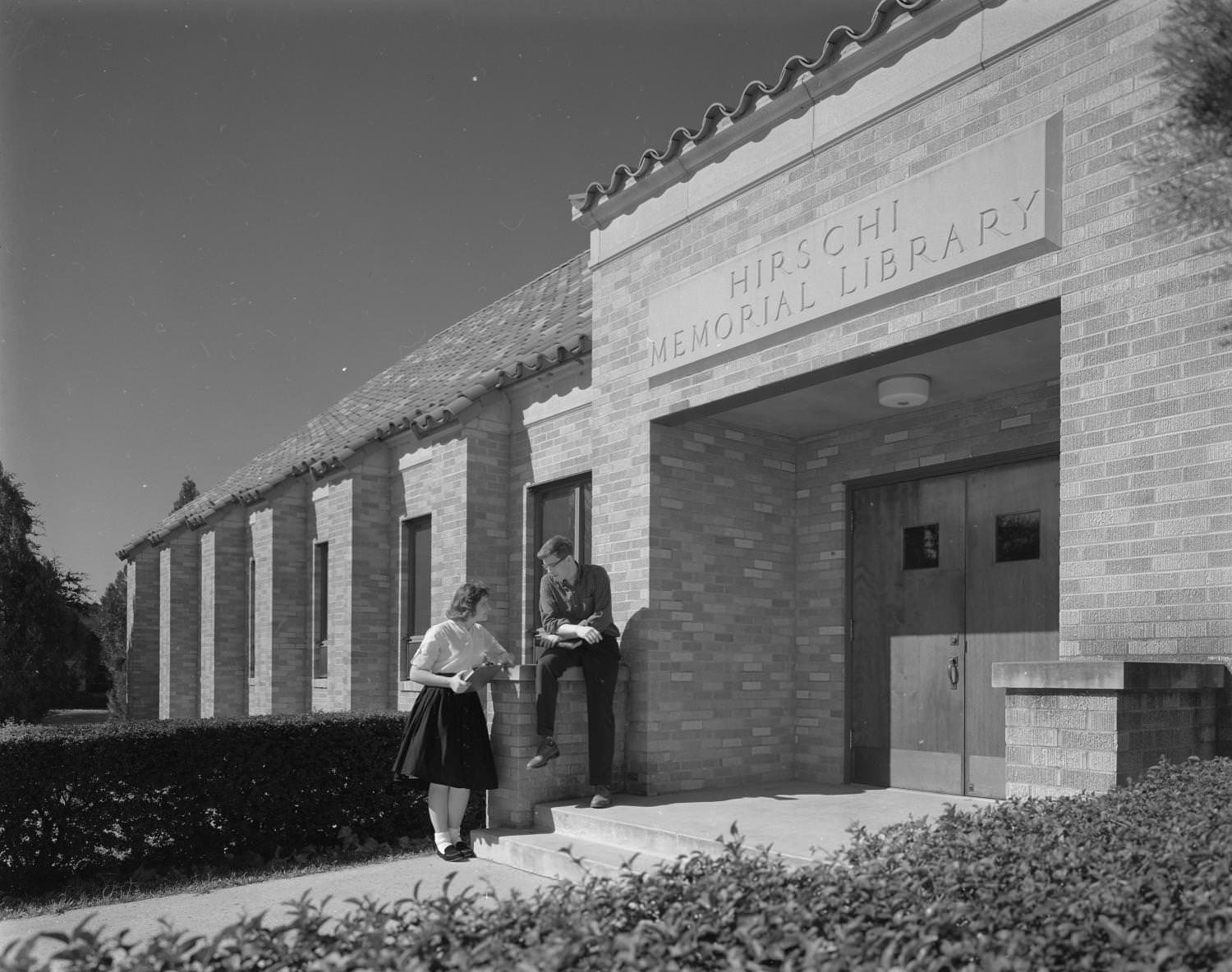 #187 Students on the steps of a library located on 3400 East Avenue at Concordia Lutheran College, 1961