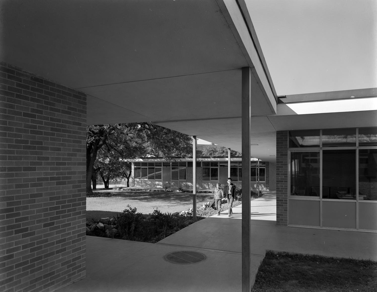 #189 Two boys walking down a covered sidewalk at school, Austin, 1961