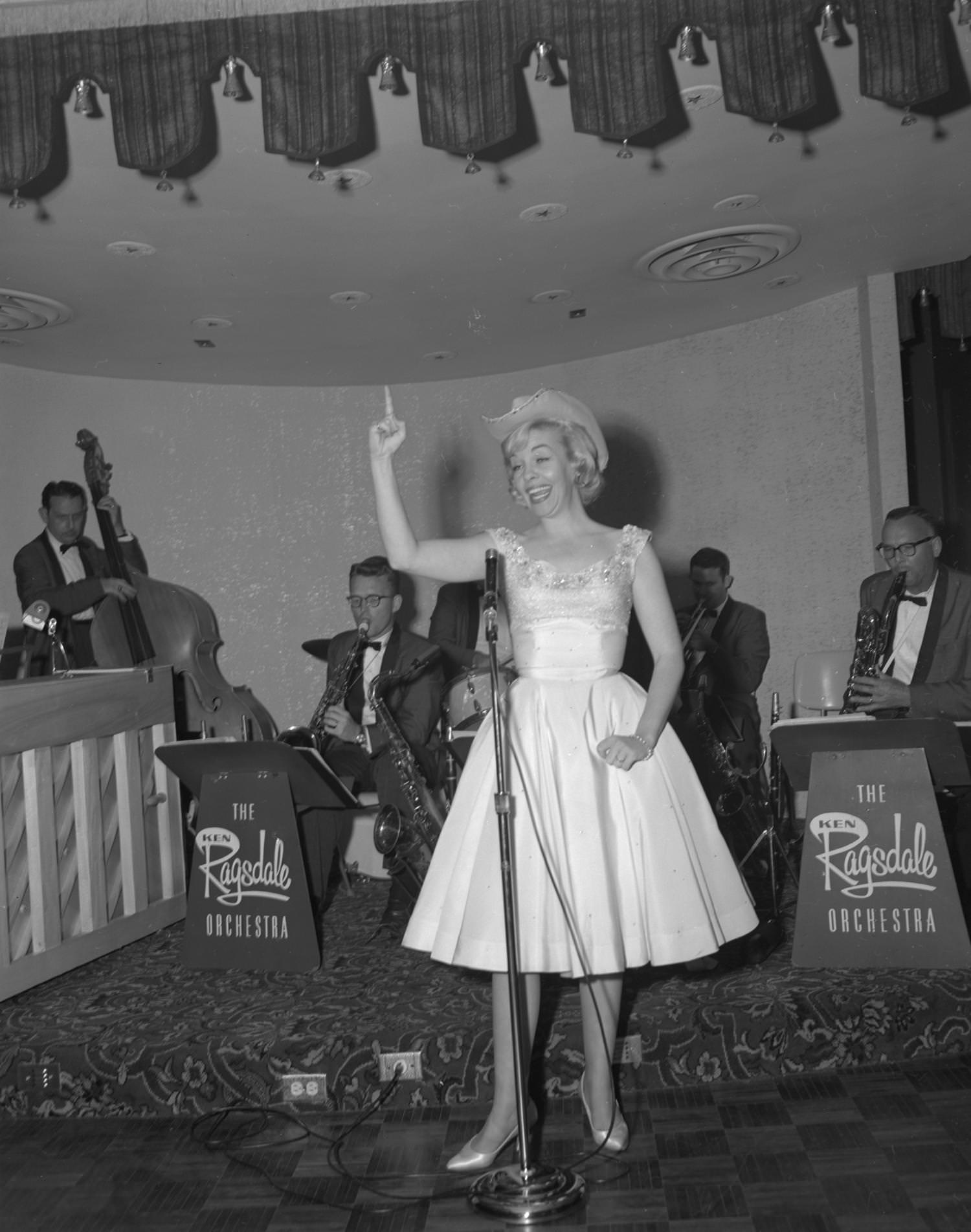 #200 A performer on stage during the opening night of Club Caravan, located at 2360 North Interstate 35, 1961