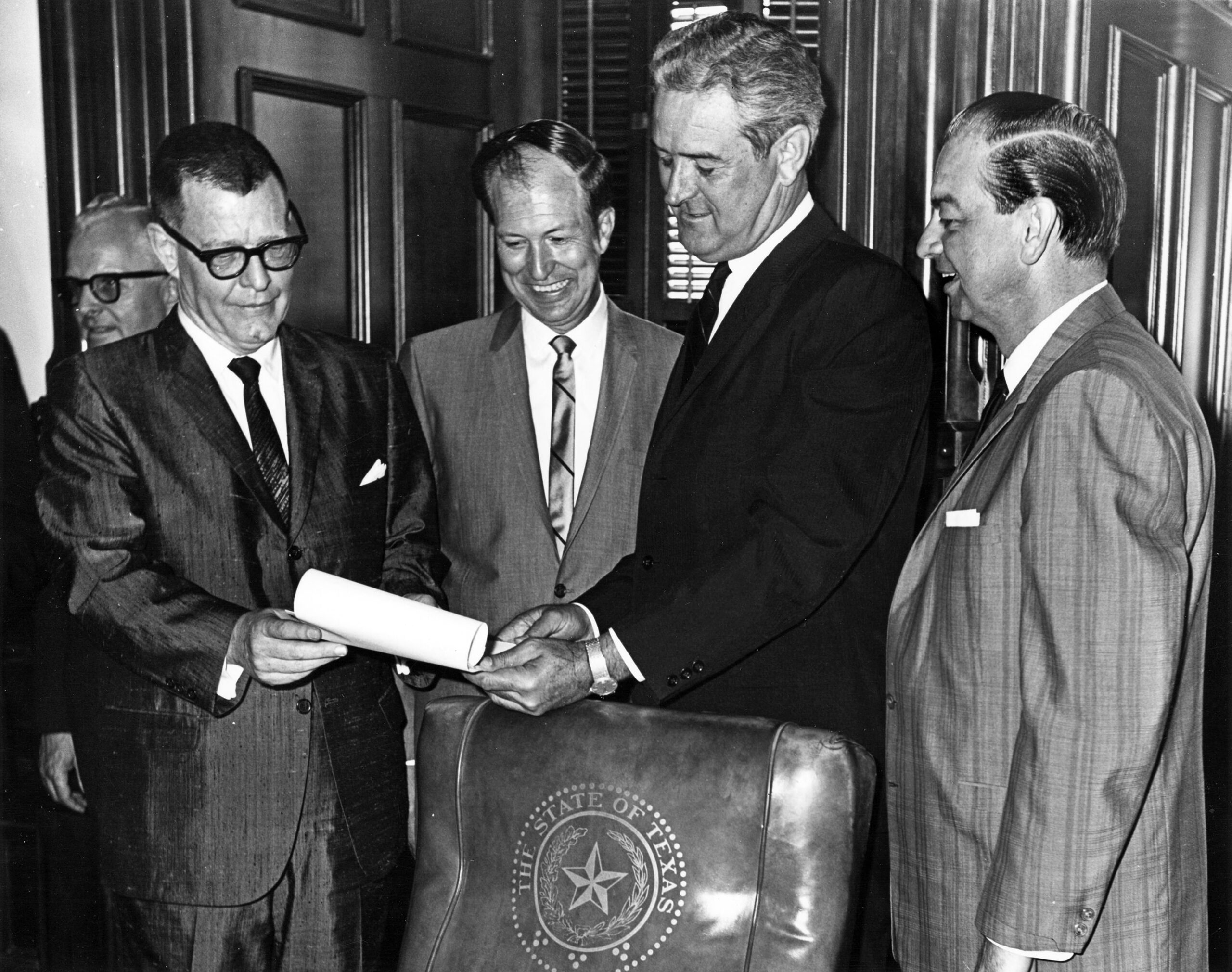 #203 Governor John Connally holding bill for transferring Arlington State College to the University of Texas System, 1965