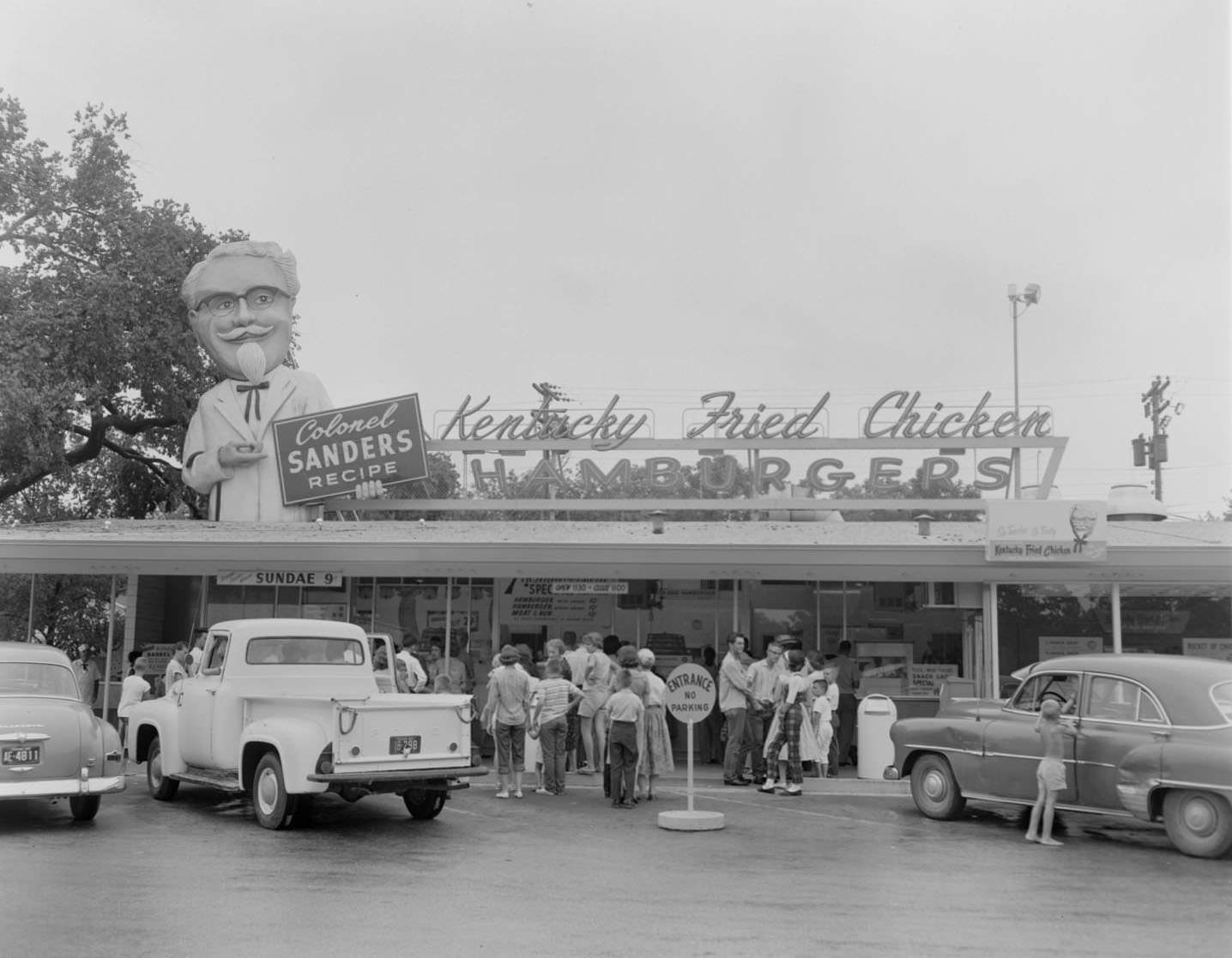 #11 Customers and parked cars in front of Kentucky Fried Chicken stand, Austin, 1960