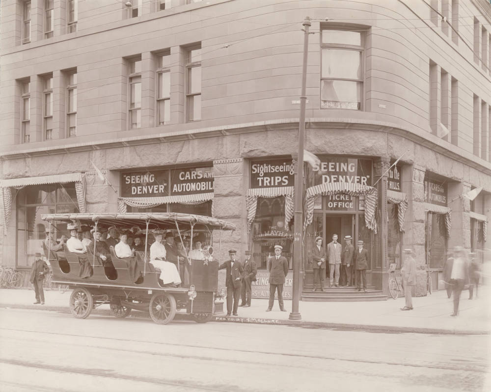 #138 Employees pose by a “Seeing Denver” electric tour coach at 17th (Seventeenth) Street and Tremont Street in Denver, 1900