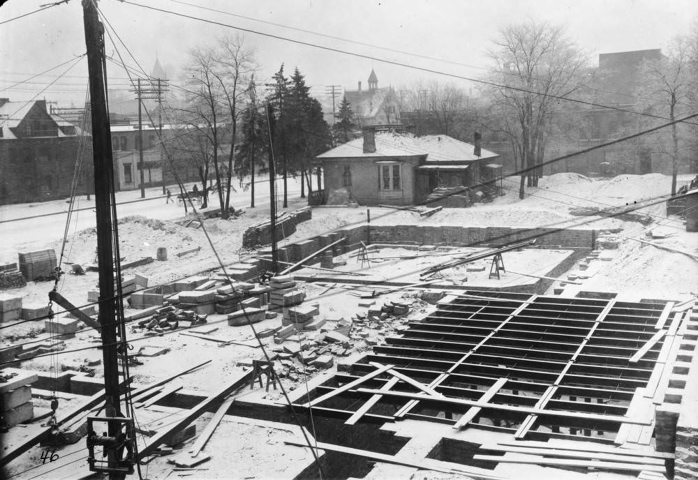 #172 Denver Public Library (Carnegie) construction consists of snow-covered basement and foundation walls and a crane in Denver, 1907