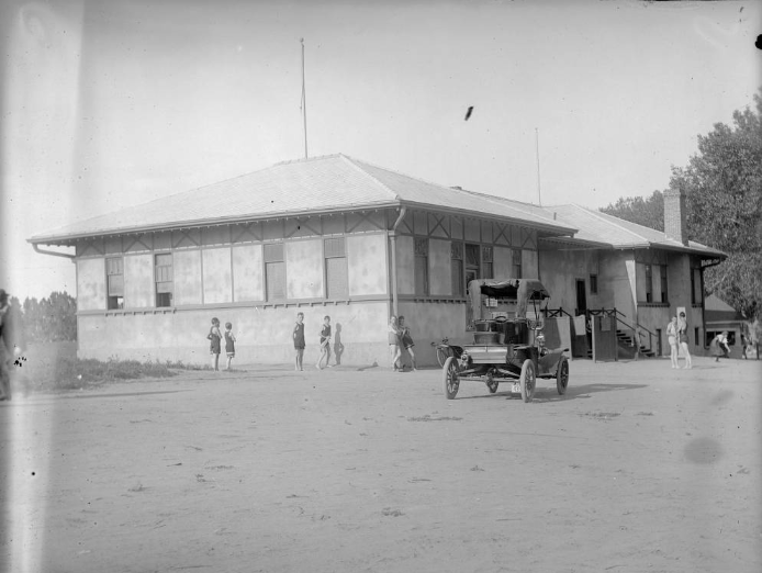 #181 Children stand near a building in Denver, 1900s