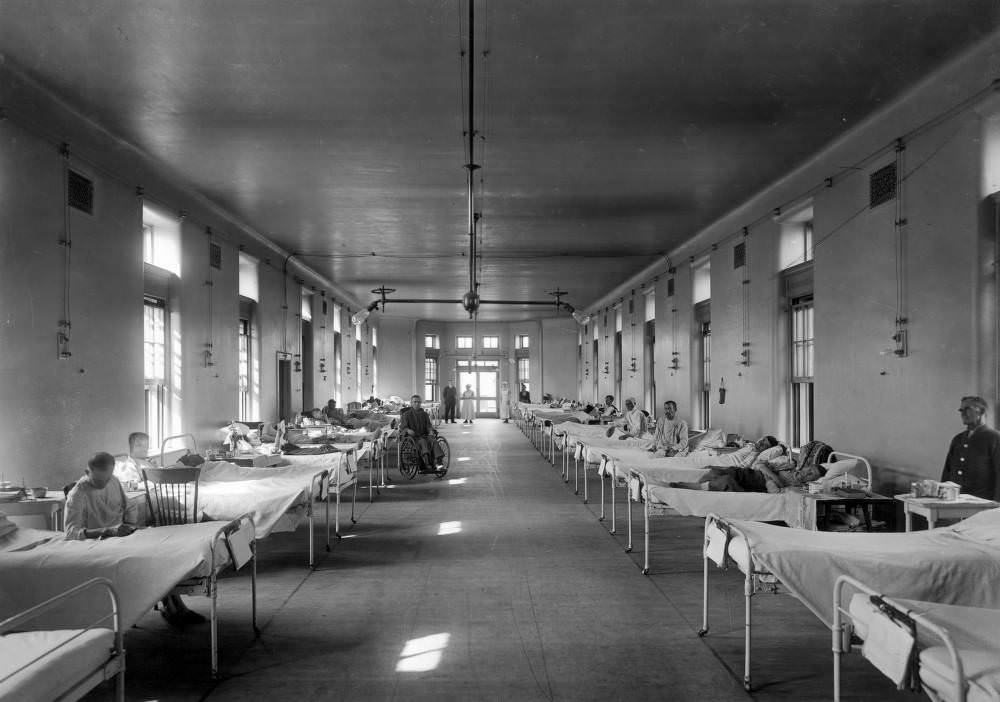 #76 Sick men lie in beds and sit in wheelchairs in the Tuberculosis Ward of Denver General Hospital in Denver, 1900