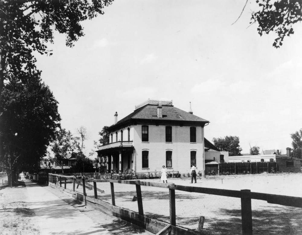#36 Jolin Wright and Nora B. Wright play croquet in the fenced playground of the Detention Home School (later the Gilliam Youth Center for Juvenile Justice) at 2844 Downing Street in the Five Points neighborhood of Denver, 1903