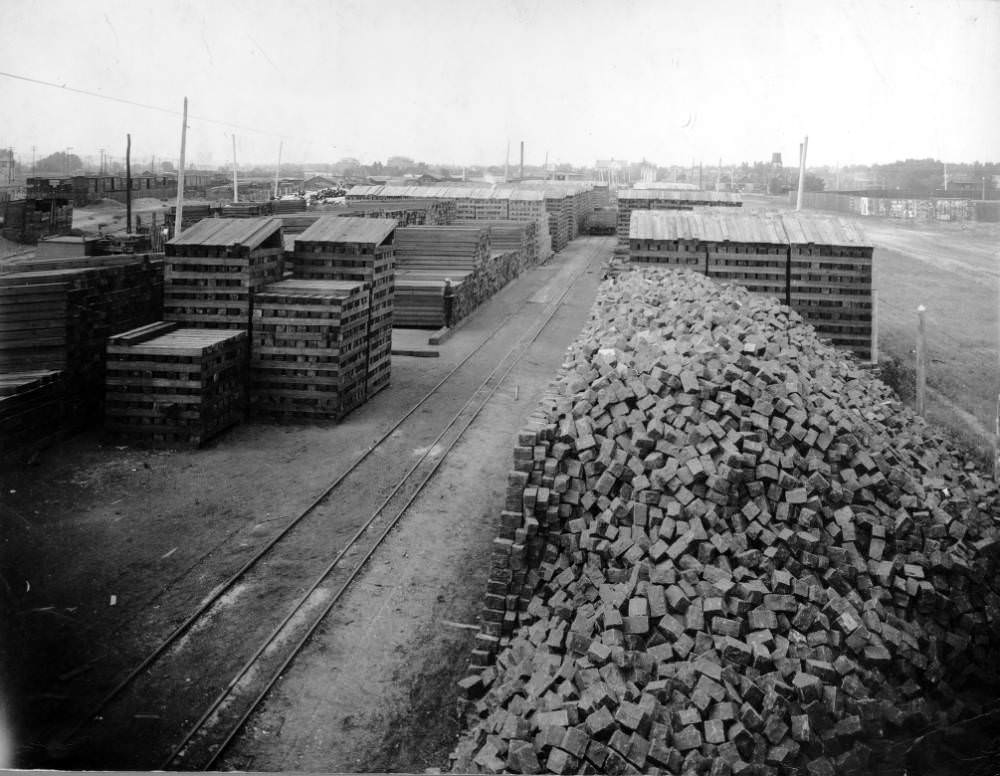 #88 Denver Tramway Company supply yard in Denver, Colorado with stacks of lumber and piles of stone cobbles, 1909
