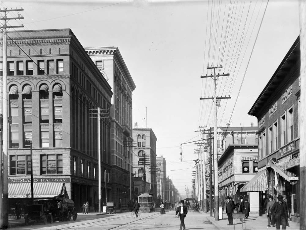 #90 View of 17th (Seventeenth) Street in Denver, Colorado. Pedestrians walk on the sidewalk and in the street. Denver City Tramway Company street car number 232 makes its way north, 1909