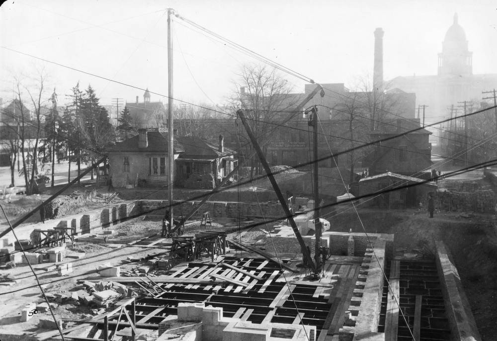 #92 Denver Public Library (Carnegie) construction consists of basement and foundation walls and cranes in Denver, 1907
