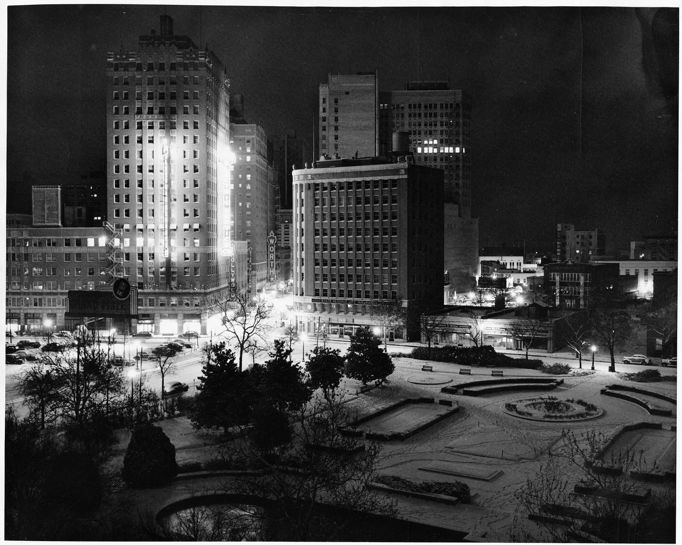 #158 Burk Burnett Park at night in the snow, at 7th and Lamar streets; lights from surrounding buildings Texas Electric Service Company and Neil P. Anderson, 1948
