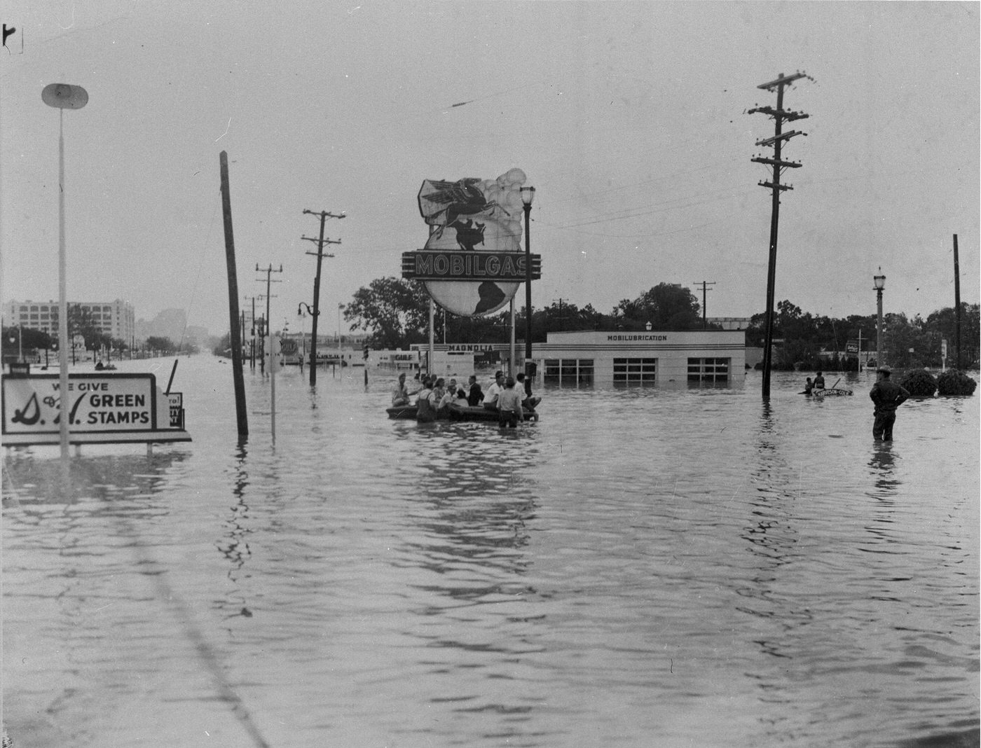 #83 Flooded street, Green Stamps sign and Mobil Gas station, 7th St., University Dr., Camp Bowie intersection, Fort Worth, 1949
