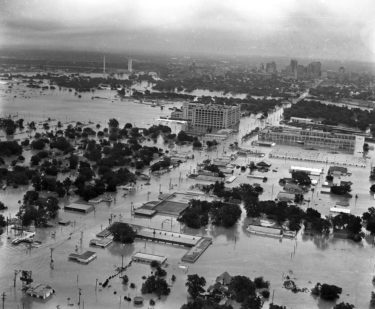 #114 Aerial of 1949 flood in Fort Worth; looking east-northeast along West 7th Street toward Montgomery Ward, Trinity River, and downtown.