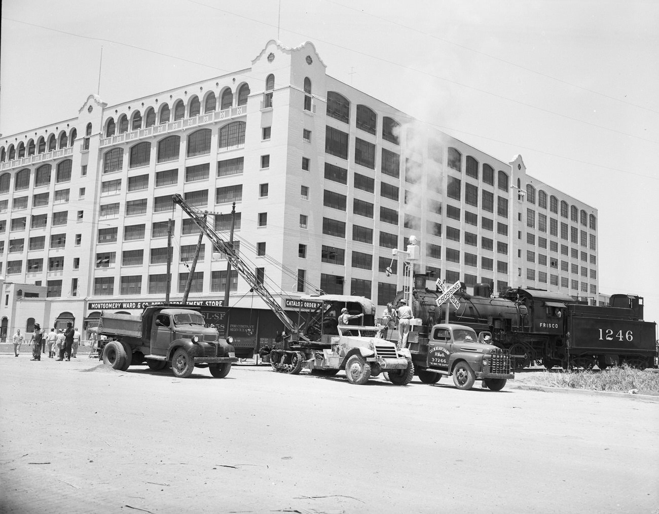 #116 Train unloading shale in front of the Montgomery Ward building, 1949