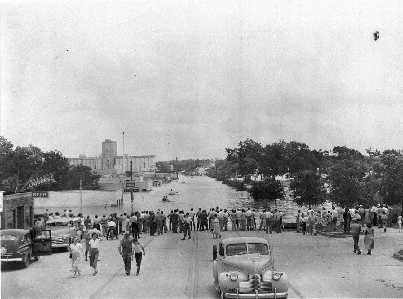 #20 People lining street at water’s edge during flood, 1949