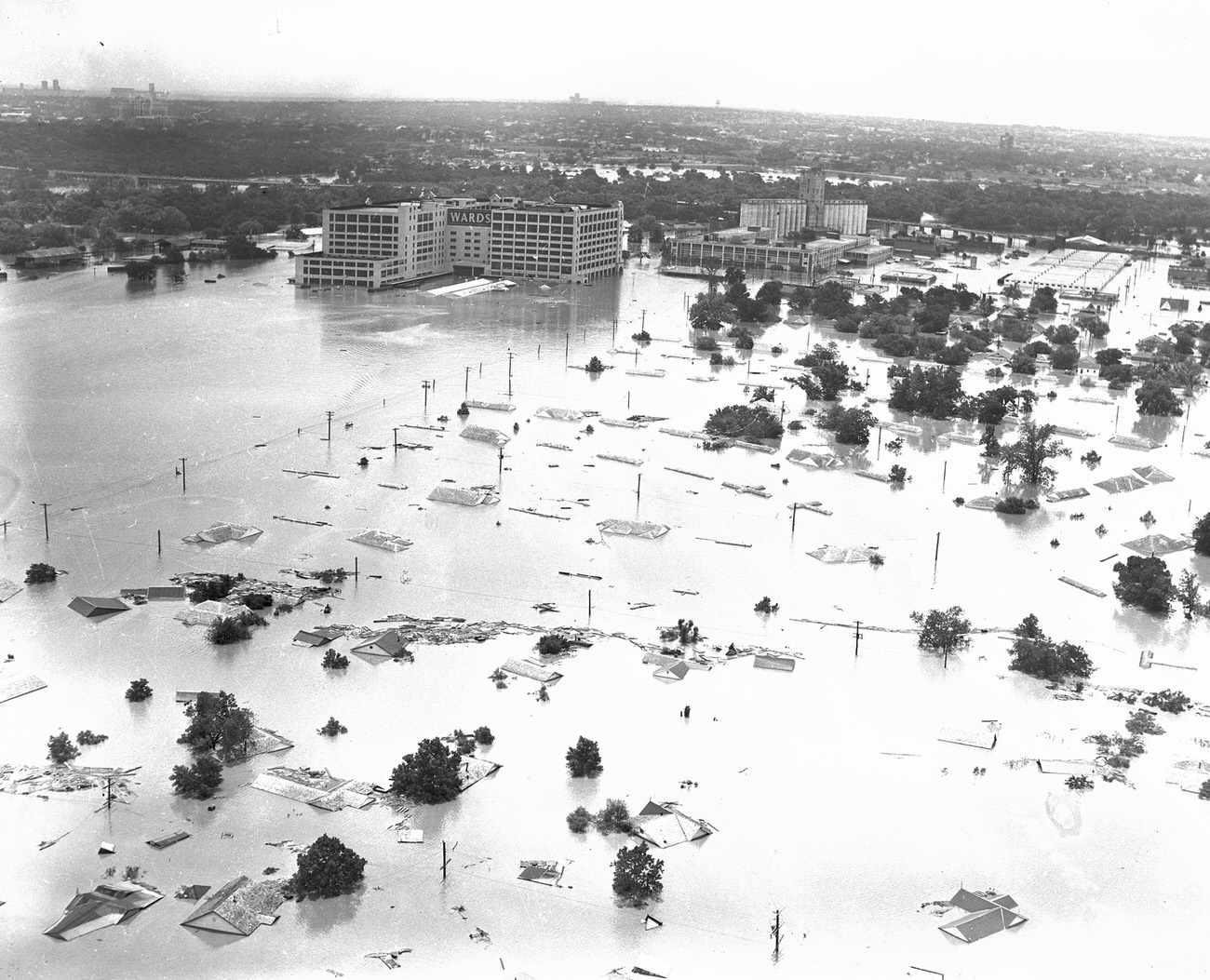 #28 Fort Worth, Texas, flood of 1949, showing 7th Street under water. The large Montgomery Ward building received extensive damage. Downtown Fort Worth is visible in the distance.