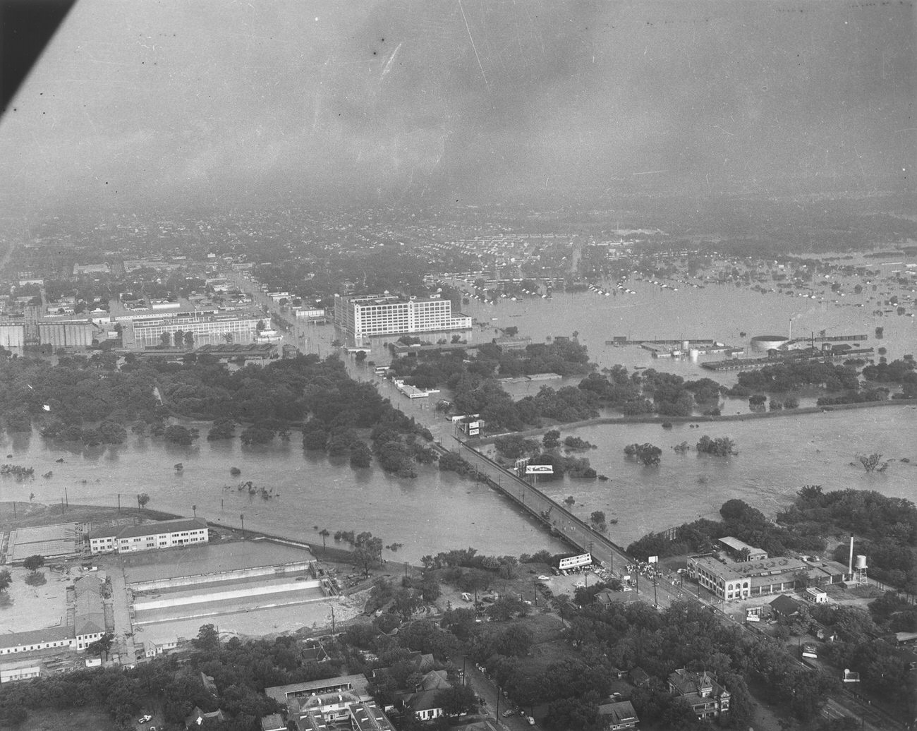 #34 Aerial view of the 1949 flood showing the 7th Street bridge and the Montgomery Ward building, Fort Worth, Texas.