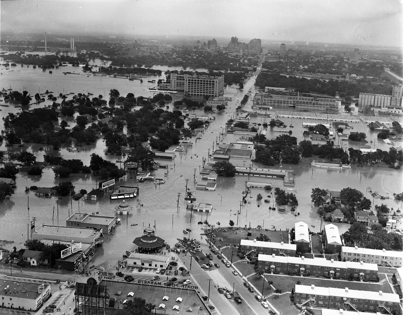 #66 Aerial of 1949 flood in Fort Worth, Texas; looking east along West 7th Street from where University Drive. and Bailey intersect with West 7th toward Montgomery Ward, Trinity River, and downtown, 1949