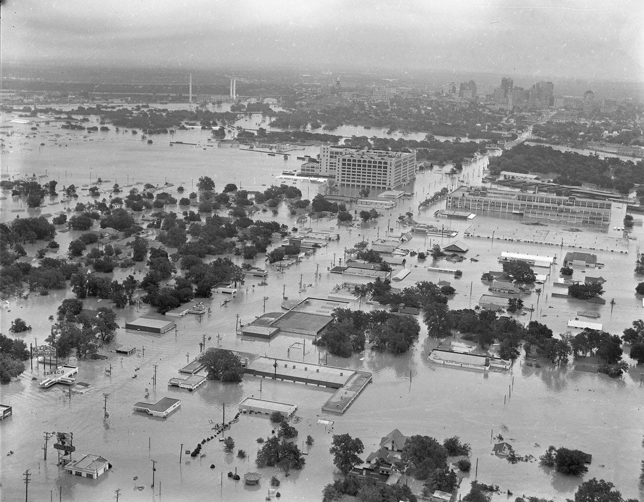 #69 Fort Worth, Texas, flood of 1949, showing 7th Street under water. The large Montgomery Ward building in the upper center received extensive damage. Downtown Fort Worth can be seen in the distance.
