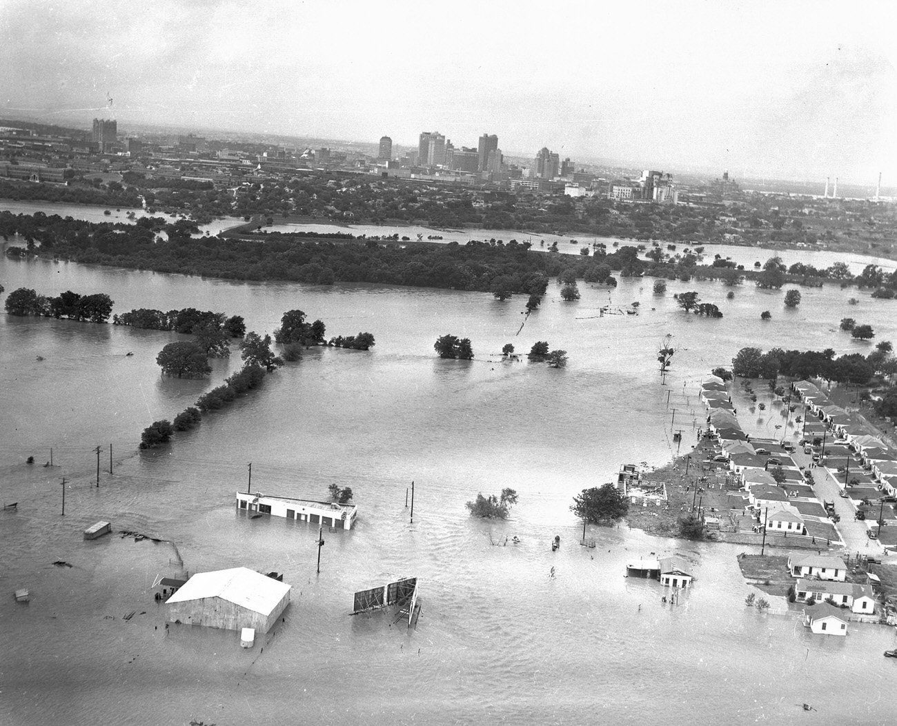 #72 Fort Worth, Texas, flood of 1949, showing submerged homes. Downtown Fort Worth is visible in the distance.
