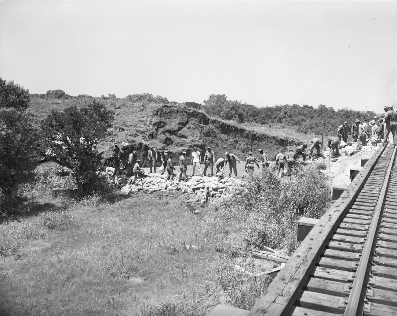 #91 Flood damage from the north railroad track off the levee off of Henderson Street, 1949