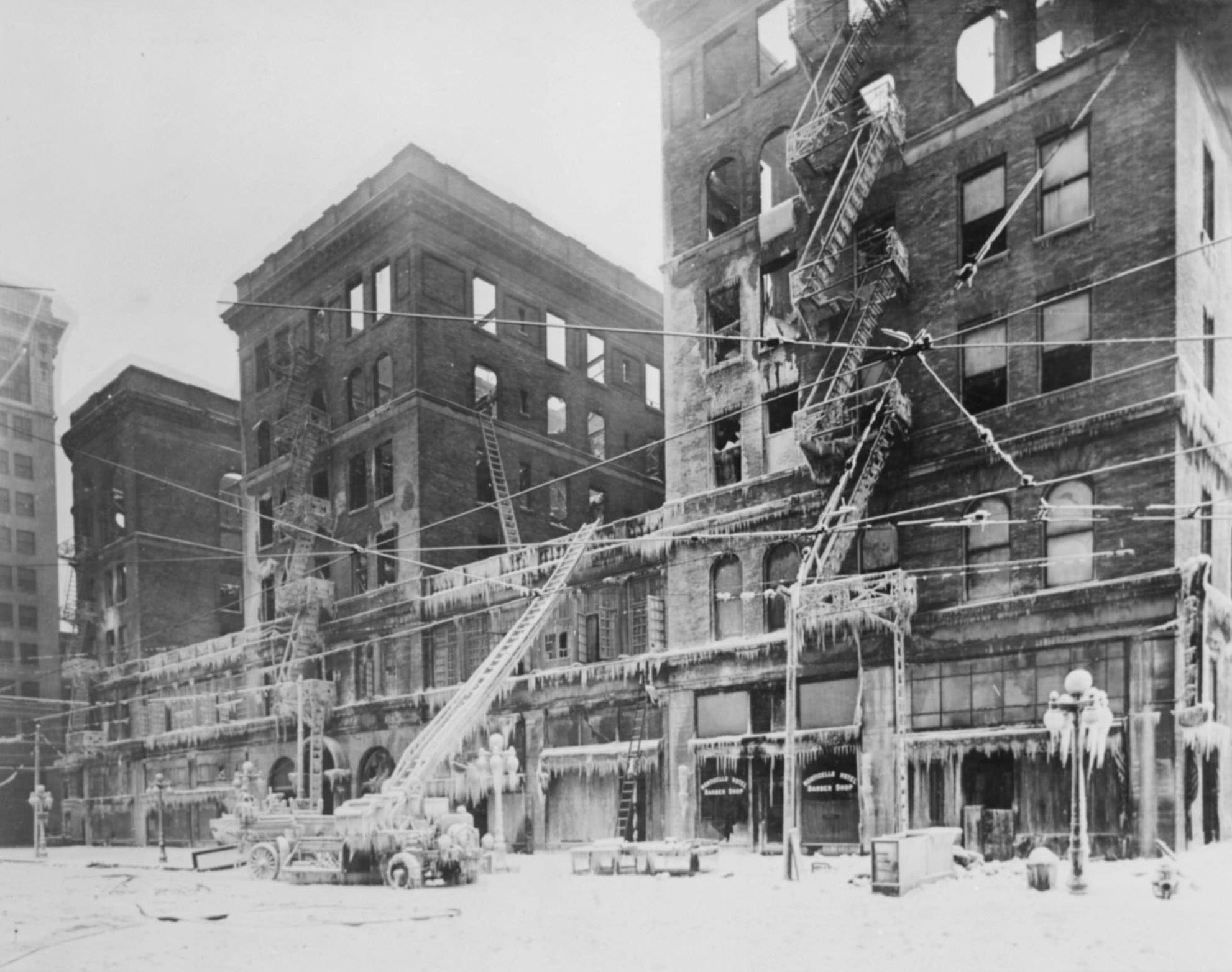 #30 View of the burned-out Monticello Hotel, Norfolk, Virginia, and fire apparatus frosted with icicles.