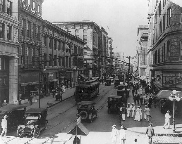 #12 Granby Street from corner of City Hall Avenue; busy street scene with autos and electric trolleys, 1915.