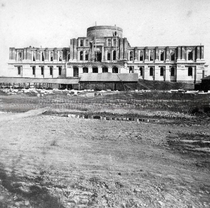 #62 Unidentified street scene with storefronts, 1875