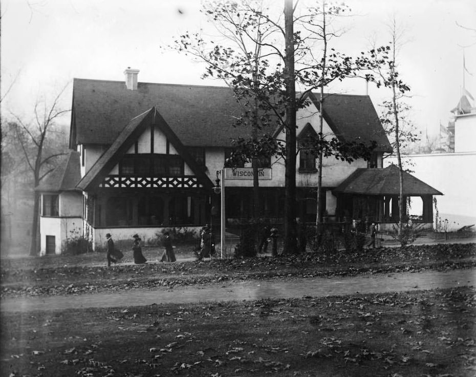 #158 Autumn leaves are on the ground, as fairgoers visit the Wisconsin pavilion at the Louisiana Purchase Exposition, 1904