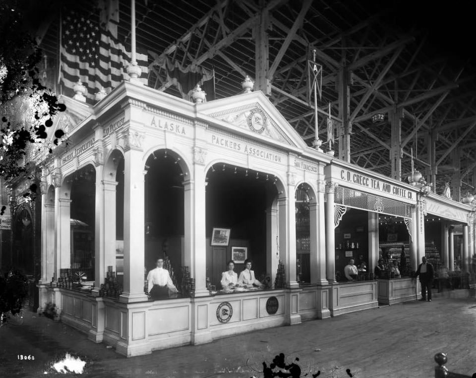 #83 Young women offered samples of Alaska salmon in the Alaska Packers Association booth in the Agriculture building at the Louisiana Purchase Exposition, 1904