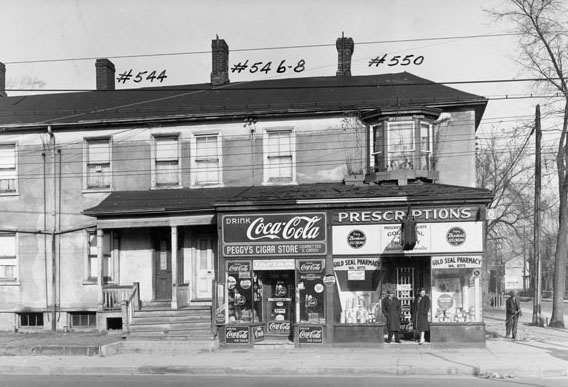 #115 Peggy’s Cigar Store and Gold Seal Pharmacy on Dundas St. E. in Regent Park, 1940s