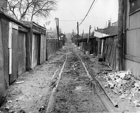 #117 A muddy laneway that had drawn the attention of the Department of Street Cleaning, 1940s