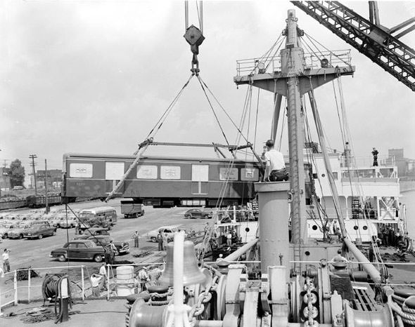 #146 Subway cars being offloaded from a shipment, 1950s