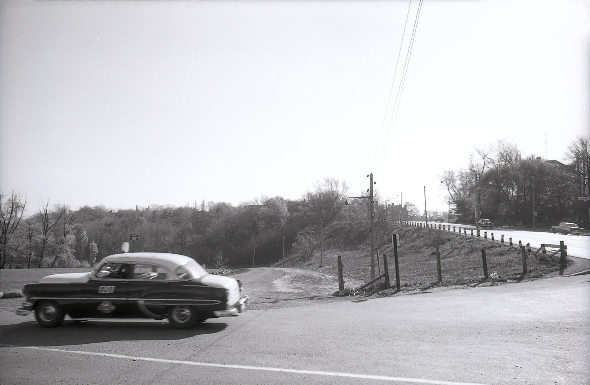 #145 Looking south on Mount Pleasant Road at Roxborough Drive as a taxi drifts by, early 1960s.