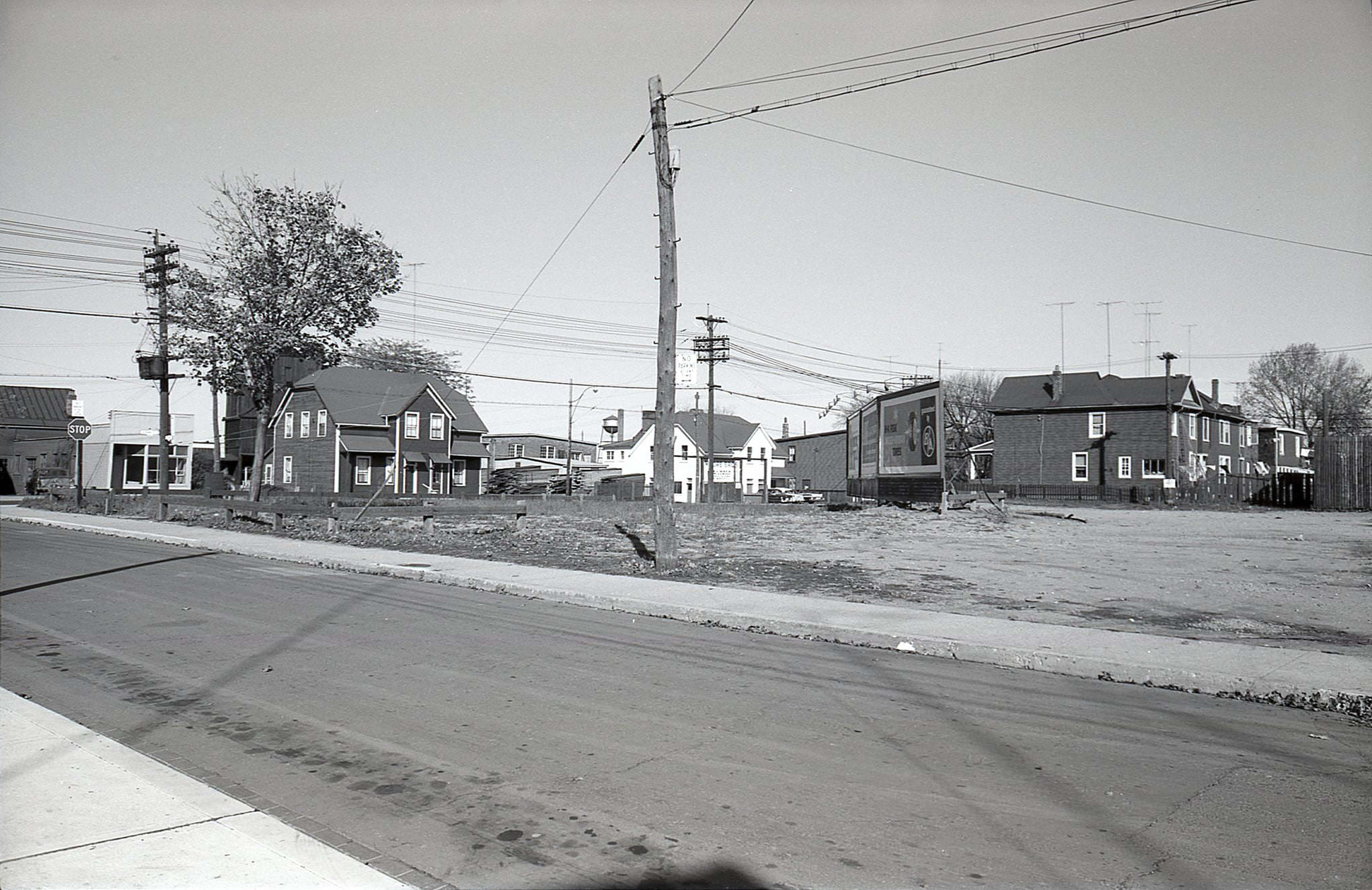 #153 Wayland Avenue, looking northeast toward Gerrard, 1960. The empty lot with billboards is now occupied by Kinsmen Manor.