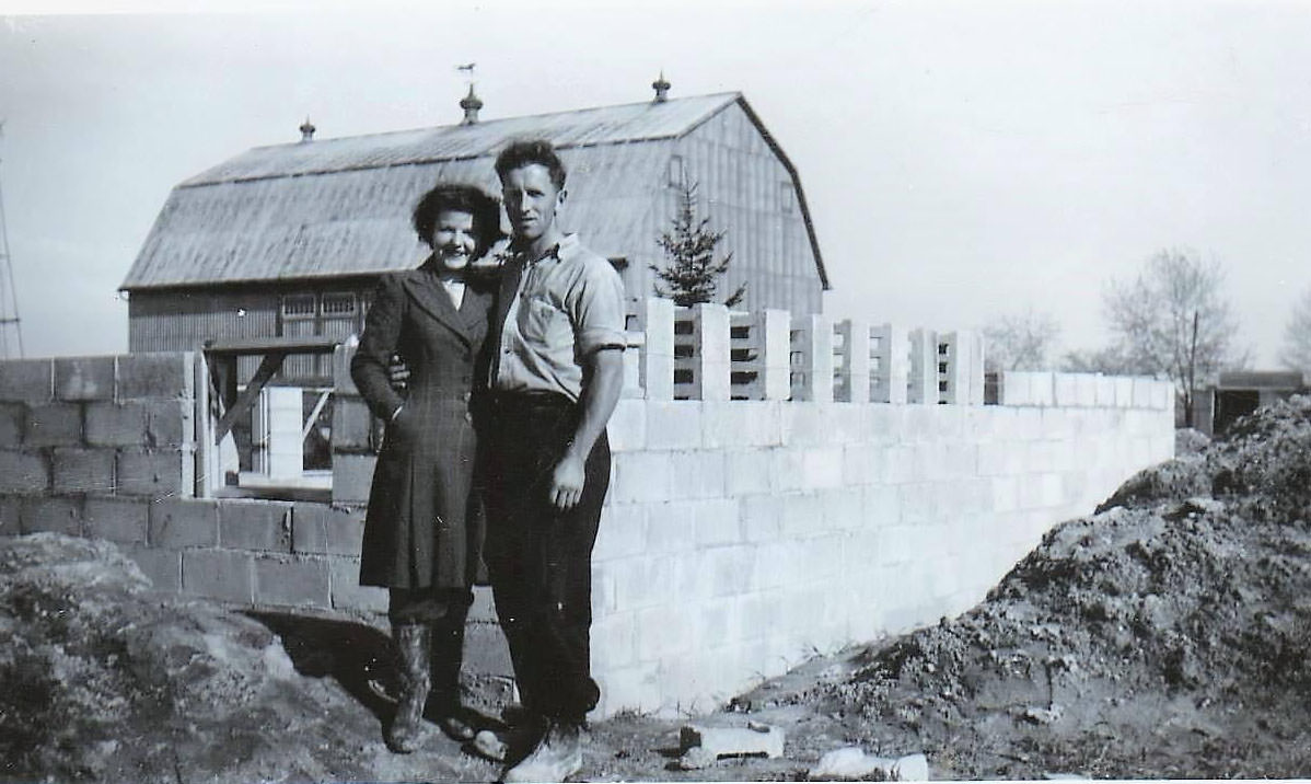 #44 A couple in front of the house they were building on Pharmacy Ave just south of Lawrence Ave, 1960s