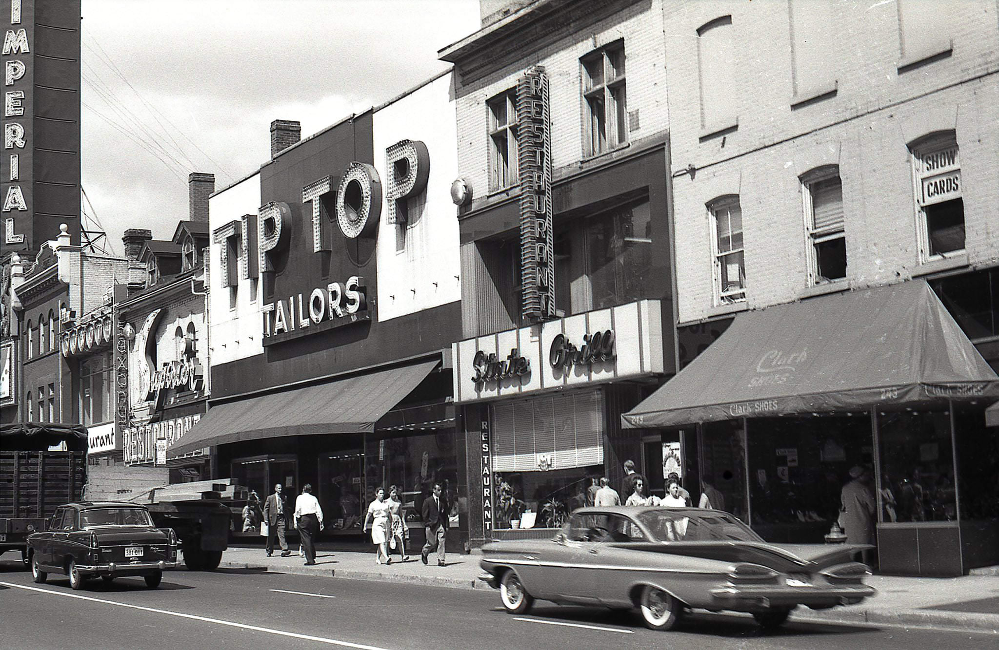 #82 243-255 Yonge Street in 1962 Clark Shoes State Grill Tip Top Tailors Superior Tea Rooms Imperial Theatre sign visible a few shops to the north