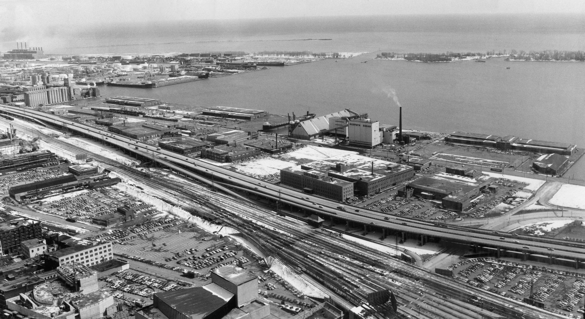 #87 A view southeast, picking up marine terminals, the Redpath Sugar plant, and the broader commercial port, 1960s