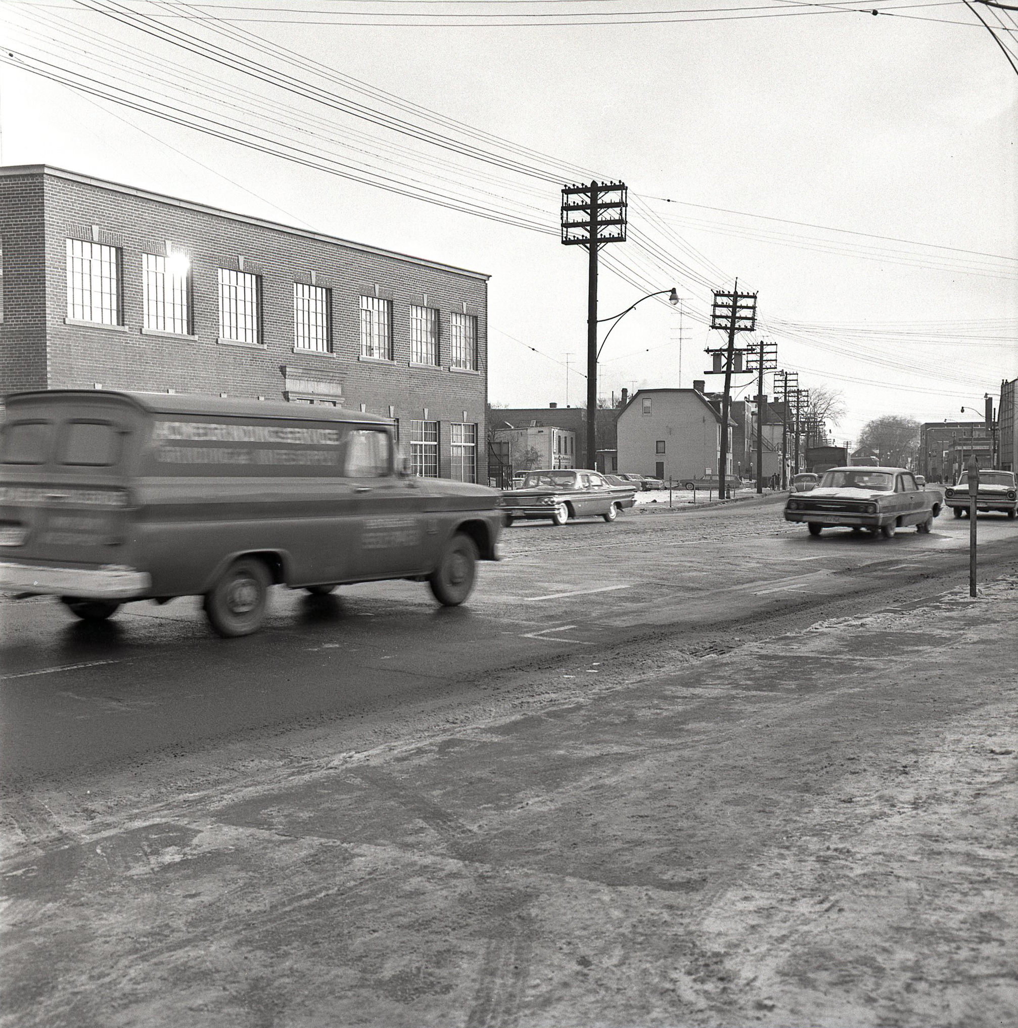 #98 Looking east along Davenport Rd., towards Avenue Rd., 1964. For context, if you zoom in, that metal fire escape in the distance still exists, and is on the side of the building that is now Avenue Diner at 222 Davenport. The diner was ‘Avenue Coffee Shops’ in 1964